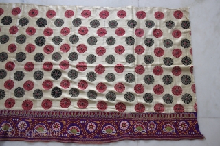 A full-sized embroidered cloth for a Chaniya (Skirt) from Kutch, Gujarat. The cloth is decorated with round flowers and the border with a colourful floral pattern all through the length of the  ...