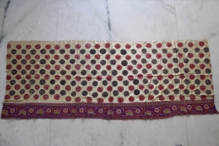 A full-sized embroidered cloth for a Chaniya (Skirt) from Kutch, Gujarat. The cloth is decorated with round flowers and the border with a colourful floral pattern all through the length of the  ...