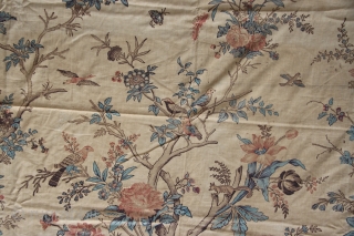An extremely rare large sized colourful Palampore block-print textile richly decorated with a tree bearing flowers and fruits, flanked by two smaller plants and surrounded by flowers, resting birds, birds in flight,  ...
