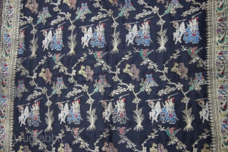 A black silk Dupatta decorated with Zari depicting birds perched on trees, tigers hunting deers, peacocks and peahens and warriors fighting on horseback and elephant back. The border, in turn, is decorated  ...