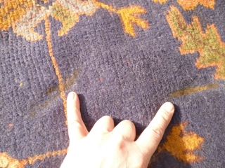 Old Oushak carpet. Over 95% full pile. Age-related wear, minor damage consistent with a roughly hundred year old antique. A couple of ragged areas at the outer border. There are a few,  ...
