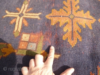 Old Oushak carpet. Over 95% full pile. Age-related wear, minor damage consistent with a roughly hundred year old antique. A couple of ragged areas at the outer border. There are a few,  ...