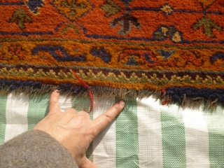 Old Oushak carpet. Over 95% full pile. Age-related wear, minor damage consistent with a roughly hundred year old antique. A couple of ragged areas at the outer border. There are a few,  ...