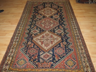 Antique Qashqai rug with triple medallion design, the medallions contain a large scale heratti design, this also has elements repeated in the field. 

Circa 1900.

There are also many small birds, animals and  ...