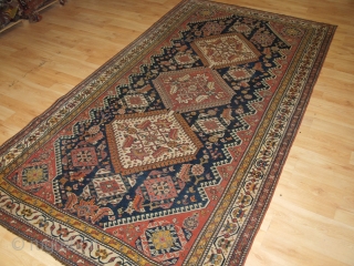 Antique Qashqai rug with triple medallion design, the medallions contain a large scale heratti design, this also has elements repeated in the field. 

Circa 1900.

There are also many small birds, animals and  ...