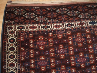 ANTIQUE YOMUT TURKMEN MAIN CARPET WITH KEPSE GUL DESIGN, CIRCA 1900.

Size: 10ft 8in x 6ft 8in (324 x 203cm).

The carpet has a rich brown ground colour with some very nice blues and  ...