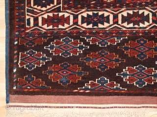 ANTIQUE YOMUT TURKMEN MAIN CARPET WITH KEPSE GUL DESIGN, CIRCA 1900.

Size: 10ft 8in x 6ft 8in (324 x 203cm).

The carpet has a rich brown ground colour with some very nice blues and  ...
