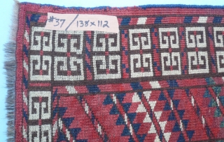 (37) Cherry-red Tekke Ensi (mihrab), 138 x 112, with a very cheery disposition. Plenty of turquoise and white as complimentary highlights, a close pile with very slight wear. Skirt is full of  ...