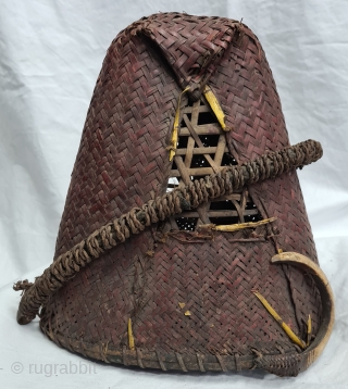 Hat, Naga People, Kalyo-Kengyu ethnics group, Northeastern India.
Cane, A red-dyed woven cane conical-shaped warrior's interwoven in typical fashion. There may have been a boar's tusk attached to the front.
Early to mid-20th century.
Its  ...