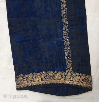 A Pair of velvet trousers in a luxurious blue colour. From Bengal.  India. Late 19th to early 20th century. The back has arrangements for suspenders with buckles made in Germany. The  ...