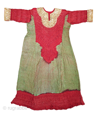 Aabha – Wedding Dress (Long Tunic).
A rare and elegant Aabha (Wedding Dress), crafted from fine silk with a beautiful Bandhani (tie-dyed resist) technique created by meticulously tying thousands of tiny knots by ...
