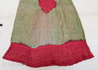 Aabha – Wedding Dress (Long Tunic).
A rare and elegant Aabha (Wedding Dress), crafted from fine silk with a beautiful Bandhani (tie-dyed resist) technique created by meticulously tying thousands of tiny knots by ...