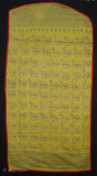 Pichwai for the Gopashtami From Gujarat India.Silver-tinsel Stamped with gum on yellow muslin cotton.Circa 1900.Its size is 82cmX100cm(DSC01463).               