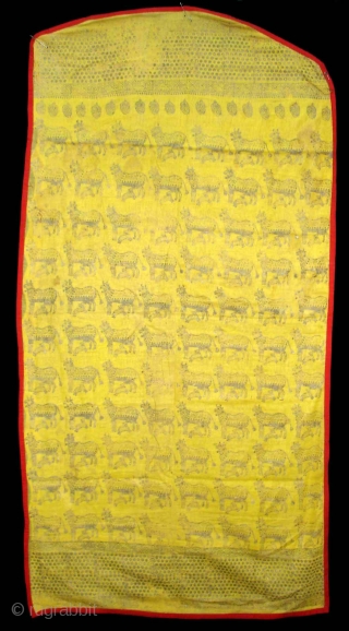 Pichwai for the Gopashtami From Gujarat India.Silver-tinsel Stamped with gum on yellow muslin cotton.Circa 1900.Its size is 82cmX100cm(DSC01463).               