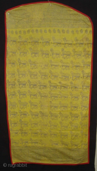 Pichwai for the Gopashtami From Gujarat India.Silver-tinsel Stamped with gum on yellow muslin cotton.Circa 1900.Its size is 82cmX100cm(DSC01463).               