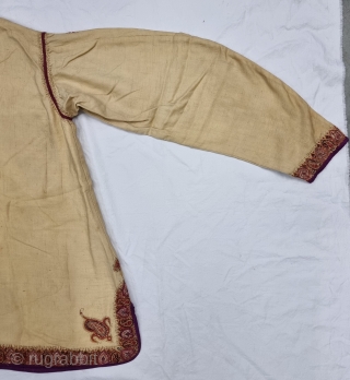 A Kashmir Embroidery Jacket-Waist Coat, Borders with Keri butis, From Kashmir, India. India. 

The front and similar motifs on the sleeves, The back and Shoulders are Decorated with Elaborate Keri Butas..

C.1875 -1900.  ...