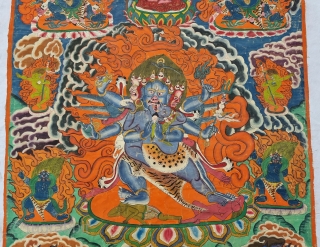 Thangka Shadbuja Mahakala From Tibet .
Distemper on cloth; recto with Tibetan inscriptions in gold identifying the various figures.

Shadbuja Mahakala is the principal protector deity of the Gelug school, indicated by the monks  ...