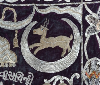 Jain Temple Hanging, Patan Gujarat, India. C.1900. Silver and gold gilt embroidery Cotton-Velvet. Its size is 77cmX123cm.   
This a holy piece, showing the Sun and Moon with twenty different marks  ...