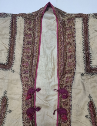 An Kashmir Embroidery Choga (Coat) Borders with Keri butis, From Kashmir, India. India. 

There are imitation pockets in the front and similar motifs on the sleeves, The back and Shoulders are Decorated  ...