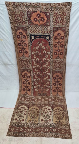 KalamkariTree of life from Lahore West (Pakistan) Punjab India. India. Kalamkari on the cotton with exotic birds and trees all within mihrab. Surrounded by a lozenge border .

Late 19th Early 20th Century.

  ...