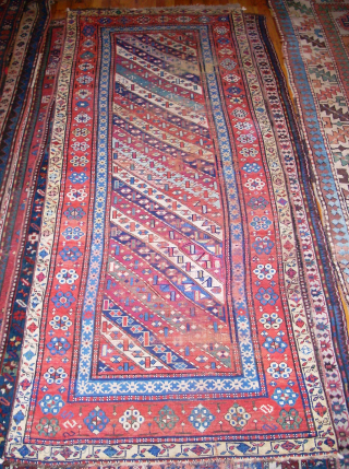 Antique Caucasian Gendje 3'5" x 8'10". Obvious wear and old repairs but still has excellent colors. Contact me directly at l_g_gerber@yahoo.com