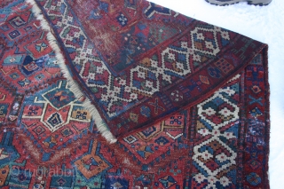 Early Sauj Bolag, 210x159 cm. rug, corrosion, some holes and wear but with some outstanding colours on very glossy wool.
Lovely main border with long and shiny pile.
Strange humanoids in the secondary border.
Some  ...