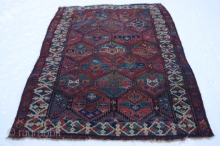 Early Sauj Bolag, 210x159 cm. rug, corrosion, some holes and wear but with some outstanding colours on very glossy wool.
Lovely main border with long and shiny pile.
Strange humanoids in the secondary border.
Some  ...