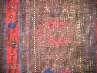 Very old Baluch main carpet, hard wear, some holes fixed with parts from old kelims, pile rugs and weft float textiles.
The red colour is very good, a lot of different blue hues  ...