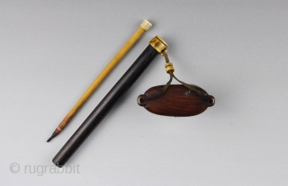 A Japanese inkwell and brush holder (yatate) in wood and staghorn. The brush holder is made of Malaysian hardwood (tagayasan) with the opening rimmed in horn.  The inkwell is carved from a  ...