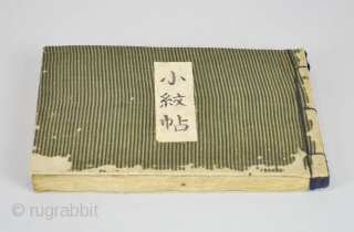 Japanese album titled Komon chō (Collection of small patterns). One volume, complete.
With 90 numbered textile samples with small decorative designs (komon) printed by stencil (katagami) on paper, mounted on 45 pages, ca.  ...