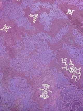 A male Tibetan Chuba (Male Robe), made from chinese damask brocade silk in deep purple color, all hand sewn. Brocade motifs comprise of dragons and phoenixes floating among the scroll of clouds,  ...