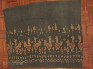A weft ikat silk tube skirt from Northeastern part of Thailand. A lovely motif of roosters and chicks in repeating fashion on dark grey background. Est age 40-60 years. Wearable condition.   ...
