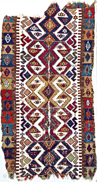 Early East Anatolian kelim one-piece weaving with white cotton ground and great colour.  Though battered,  the piece is virtually its original size and format: parts of both the original ends  ...