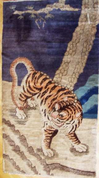 Early 20th century Baotou tiger rug. They are generally associated with tantric rituals whilst Chinese tiger rugs celebrate the fierceness and courage of the tiger as the protector against demons and evil  ...