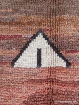 MOROCCAN BERBER MIDDLE ATLAS RUG. An unusual example from the region of Mrirt displaying the various shades of browns in lines across the field which is typical of their work. The weaver  ...