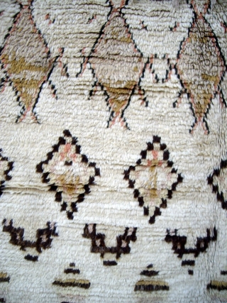 MOROCCAN MIDDLE ATLAS BERBER RUG which falls under the Beni Ourain group and is probably the work of the Ait Youssi tribe. It has silky undyed wool and delicate highlights of most  ...