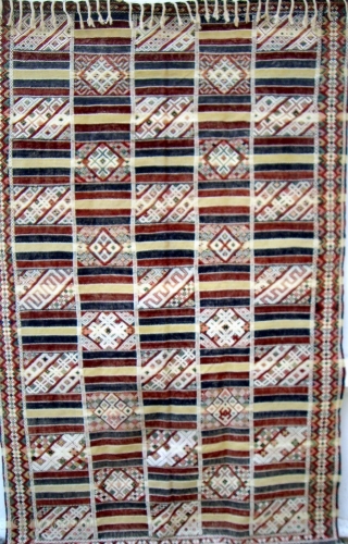 MOROCCAN MIDDLE ATLAS FLAT WEAVE/KILIM which, although not old, displays an exceptional degree of workmanship. The fine weave and intricate embroidery combine to make a pleasing combination of soft colours. The cape,  ...