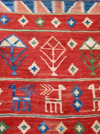 OLD FARS KILIM containing the typical designs woven by rural weavers of repeated flower heads, bushes and shrubs seen from the sides and animals which are probably goats. The weaving is very  ...