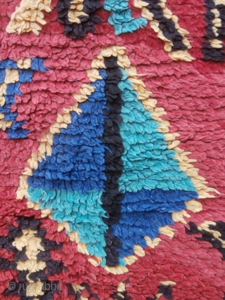 MOROCCAN BERBER HIGH ATLAS RUG A bright, colourful rug with a random scattering of Berber designs and motifs throughout the field. The colours are a deliberate contrast to the endless browns and  ...