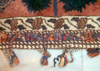 AFSHAR TRIBAL TENT BAG which is rare because of its inscription in the field. The field is dominated by a central tree with songbirds at each lower side. At the top there  ...
