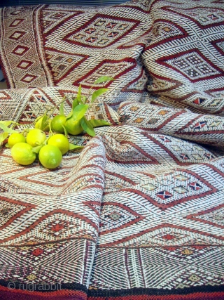 MOROCCAN BERBER MIDDLE ATLAS FLAT WEAVE/KILIM. An old beautifully embroidered `hanbel`or cover from the Ait Arfur Berber group in the Middle Atlas. The intricate white designs are created by the use of  ...