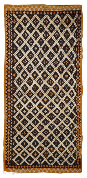 MOROCCAN HIGH ATLAS BERBER CARPET. A large piece from Ait Ouiaouzguite with exceptionally glossy, fine, hand spun undyed wools. Henna has been used in the border work. It dates from the first  ...