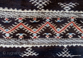 MOROCCAN HIGH ATLAS HORSE BLANKET in which the foundation is a flat woven kilim of undyed black goat hair. The design is of white wool with some colour highlights. This combination of  ...