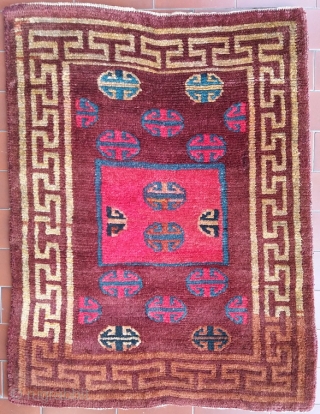 Excellent, genuine old Tibetan rug with simple and archaic multicolor shou in a large yellow frame, mat size (circa 73 by 59 cm at widest points), nice abrash (more faithful colours can  ...