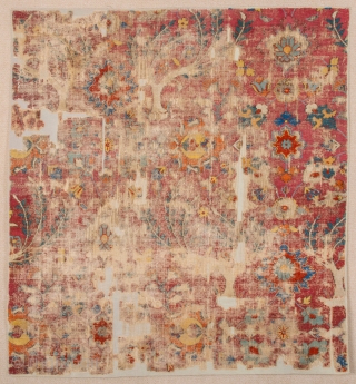 Persia Mid 17th Century Khorasan or Esfahan Rug Fragment.A fragment of a carpet woven in the court workshops of Esfahan. The primary design consists Lovely red while further spiralling vines decorated with  ...