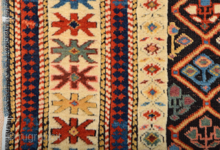 A small-format Kuba with a rare design. A repeat of flowers arranged into rows is seen in the dark brown field.19th Century Shirvan Kuba Rug The white-ground main border contains large star-shaped  ...
