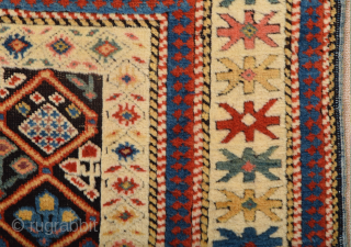 A small-format Kuba with a rare design. A repeat of flowers arranged into rows is seen in the dark brown field.19th Century Shirvan Kuba Rug The white-ground main border contains large star-shaped  ...