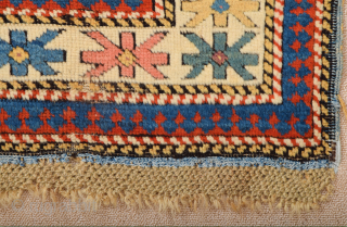 A small-format Kuba with a rare design. A repeat of flowers arranged into rows is seen in the dark brown field.19th Century Shirvan Kuba Rug The white-ground main border contains large star-shaped  ...