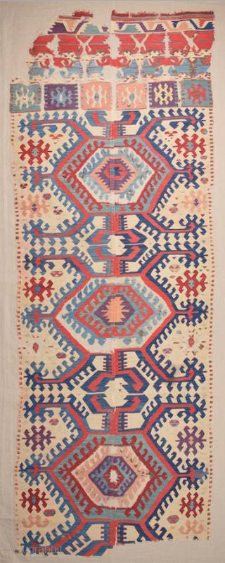 This impressive white-ground kilim is a weaving of the Hotamis Turkmen of the Konya region. It is woven in one piece, so unlike the two-panel kilims of this group there is no  ...