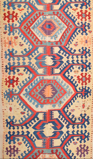 This impressive white-ground kilim is a weaving of the Hotamis Turkmen of the Konya region. It is woven in one piece, so unlike the two-panel kilims of this group there is no  ...